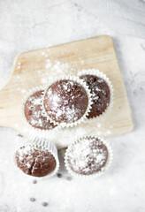 Chocolate muffins with sugar. on a gray background.dessert