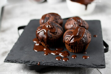 Chocolate muffins with sugar. on a gray background.dessert