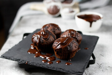 Chocolate muffins with sugar. on a gray background.dessert
