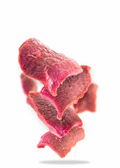 Falling raw beef meat isolated on white background