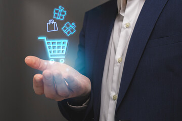 Businessman with shopping cart icon in his hand. Online shopping concept