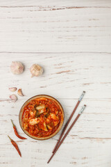 Kimchi is a dish of Korean cuisine made of cabbage and pickled (fermented) vegetables with red hot pepper and garlic. Close-up, selective focus