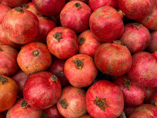 Close-up of the ripe pomegranates. Background of red tropical fruits.