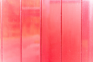 Fototapeta premium Painted shiny red wood wall outside.