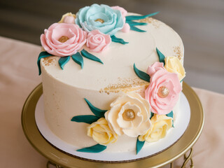 Elegant floral cake with pastel rose decorations on cake stand