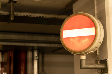 Illuminated no passage sign at the entrance of an underground area.
