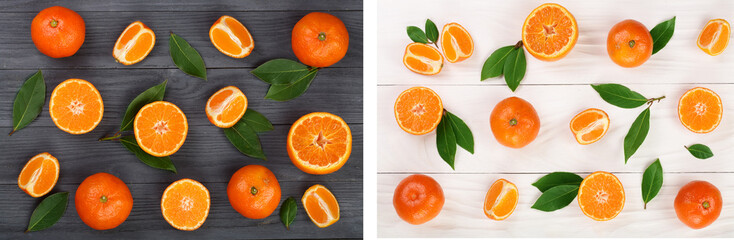 orange or tangerine with leaves on black and white wooden background. Flat lay, top view. Fruit composition