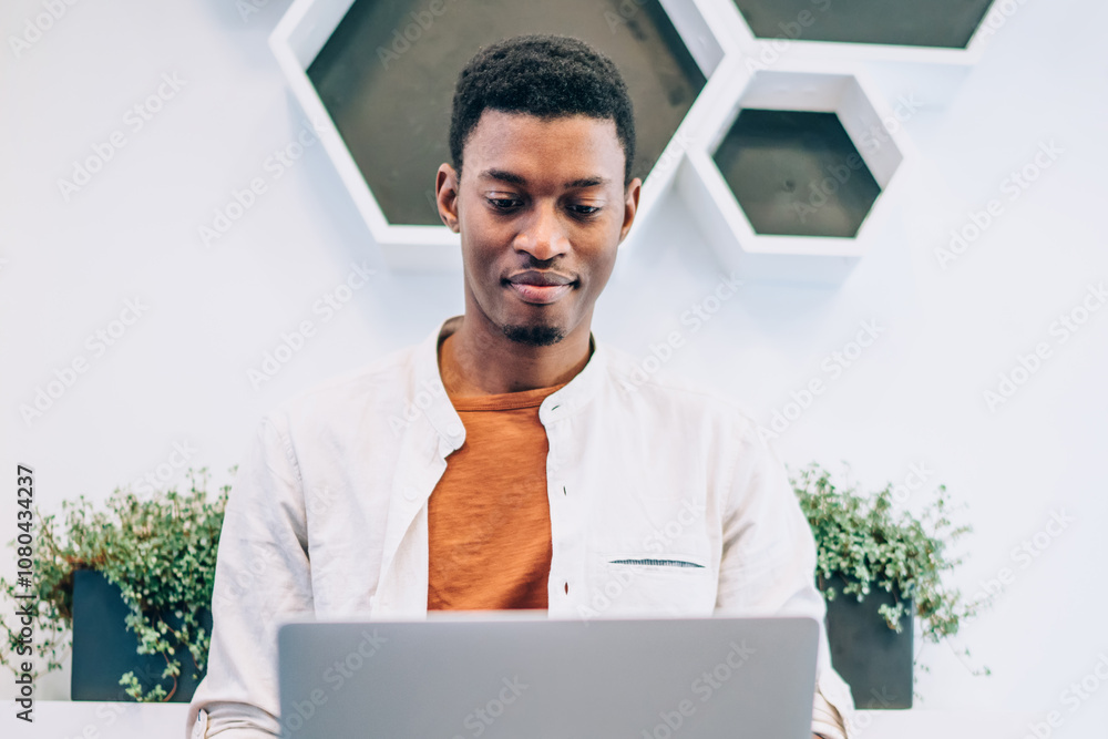 Poster skilled male programmer with dark skin developing web platform for it professionals using 4g wireles