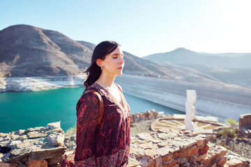 Beautiful latin woman with eyes closed enjoying time outdoors in Huasco Valley, mindfulness and wellbeing concept