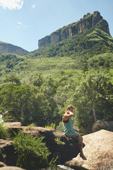 Woman, mountain and rock for hiking, travel and tropical holiday outdoor with peace on weekend break. Female person, nature and explore for relax, trip and vacation with sunshine, calm or mindfulness