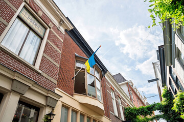 Ukrainian flag flying on a building facade in Alkmaar, Netherlands, representing support and solidarity with Ukraine