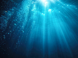 Obraz premium Mesmerizing beams of sunlight penetrate the deep blue water, illuminating bubbles and evoking a sense of tranquility and mystery beneath the ocean. Generative AI
