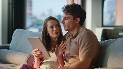 Joyful spouses shopping with tablet at home couch closeup. Happy couple enjoying - Powered by Adobe