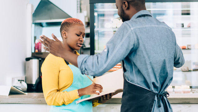 Ethnic adult cafe owners disputing in workplace