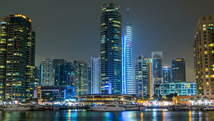 Obraz premium View of Dubai Marina towers and yacht in Dubai at night timelapse hyperlapse