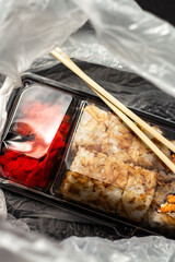 Sushi roll set in take away package in delivery bag. Food delivery concept. Food in plastic packaging