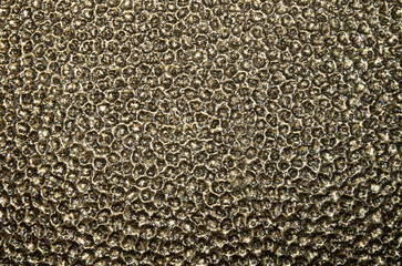 Brown decorative embossed metal surface closeup