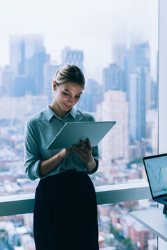 Formal businesswoman using tablet in office