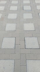 Obraz premium Grey concrete tiles in a grid pattern.