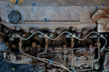 Close-Up of a Vintage Rusted Engine Block with Fuel Lines and Bolts