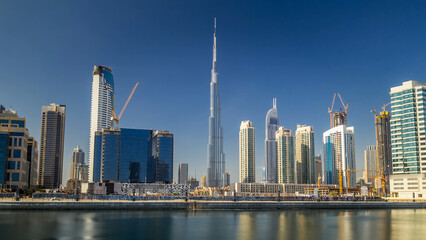 Obraz premium Skyline of Dubai's business bay with skyscrapers at day time timelapse hyperlapse.