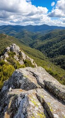 Obraz premium A panoramic view of a mountain range with rolling hills and a clear blue sky.
