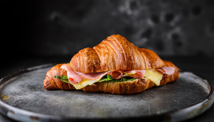 Fresh croissant with ham and cheese. Tasty food for lunch. Delicious bakery.