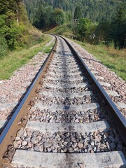 Fototapeta premium Railway tracks, rails and crushed stone. Industrial landscape. Railway junction. Heavy industry, railway track. 