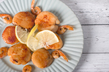 fried scallops on a plate, seafood. Serving dishes in the restaurant