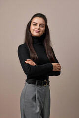 pretty businesswoman lady with crossed arms in black sweater isolated on gray background