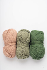 Three skeins of yarn green and brown color