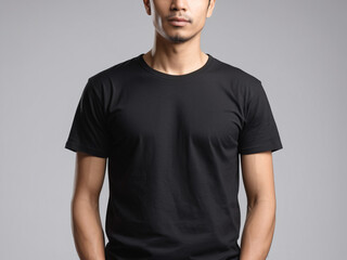 Obraz premium A Man wear a plain black T-Shirt Isolated with Grey Background