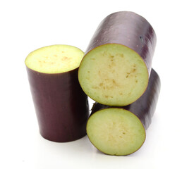 Aubergine, Solanum melongena, egg plant, single ripe fruit and halved fruit next to it - stock photo	
