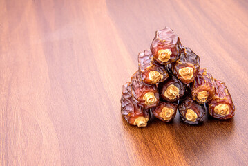 Dates or kurma on a wooden table, the favorite food of the holy ramadhan month.