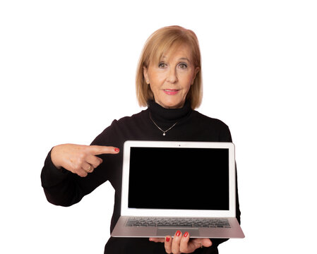 Senior woman showing laptop computer screen isolated over transparent background. PNG transparent.