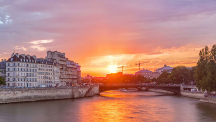 Obraz premium Le Pont D'Arcole bridge at sunset with people and boats timelapse, Paris, France, Europe