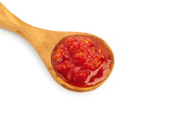 Tomato sauce in wooden spoon on a white background