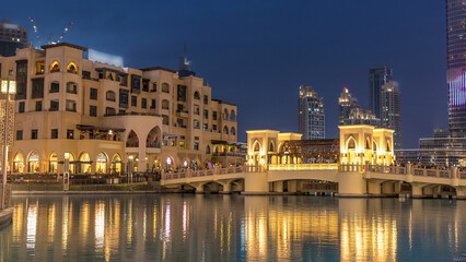 Naklejka premium The bridge near the biggest musical fountain in Dubai day to night timelapse. Dubai, UAE