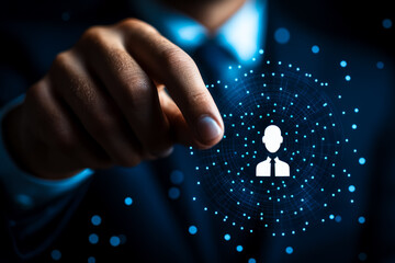 A close-up of a person pointing towards a digital icon of a user profile surrounded by a network of connections, symbolizing online networking, technology, and digital communication.