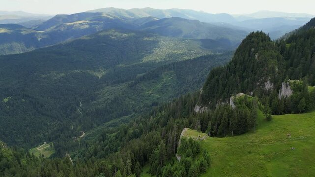 The forested peaks of the Piatra Mare mountains , in the middle of the Carpathian mountain range in Transylvania, Romania, aerial drone view.