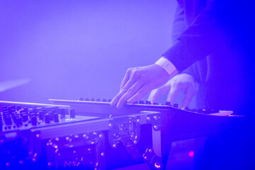 Hands of a DJ at work live on stage
