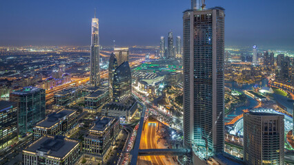 Dubai Downtown day to night timelapse modern towers panoramic view from the top in Dubai, United Arab Emirates.