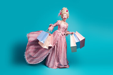 Full length photo of young woman hold bags run empty space wear renaissance queen costume isolated on teal color background