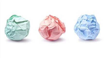 Fototapeta premium Colorful Crumpled Paper Balls in Green, Pink, and Blue on White Background for Creative and Artistic Projects, Crafting, or Office Use