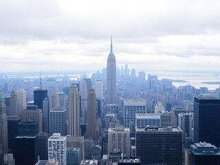 A sea of skyscrapers stretches across Lower Manhattan's horizon, their peaks disappearing into the clouds, high-rise buildings, urban sprawl, concrete jungle
