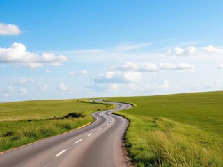 Fototapeta premium A winding road disappears into the distance as it passes through a meadow under a clear blue sky with white clouds drifting by, sunny day, vastness, road
