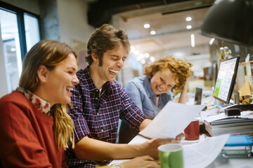 Small group of young office workers working on a project together