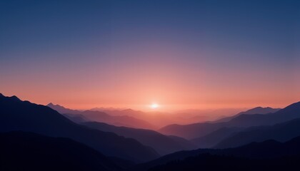 Fototapeta premium Majestic Mountain Range Silhouettes in Purple and Orange Tones at Dawn with Misty Valleys