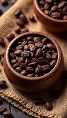 Fototapeta premium close-up of coffee beans in wooden bowls on burlap fabric