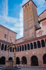 Fototapeta premium Wheel and water noria in arcaded churchyard in Basilica Santo Stefano Sanctuary, Bologna ITALY